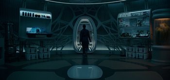 Movie still from “The Midnight Sky” (2020), directed by George Clooney – A man standing in front of an open door; Wide shot, Low angle