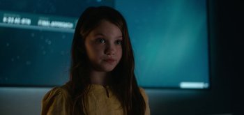 Movie still from “The Midnight Sky” (2020), directed by George Clooney – A little girl with long brown hair and a yellow shirt; Close Up shot, Over the shoulder angle
