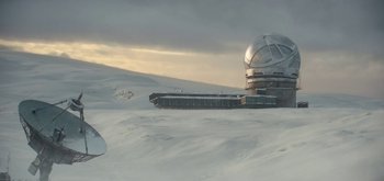 Movie still from “The Midnight Sky” (2020), directed by George Clooney – A large building on top of a snow covered slope; Extreme Wide shot, High angle
