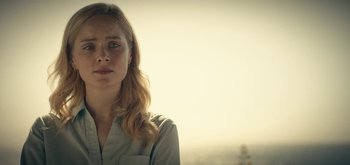 Movie still from “The Midnight Sky” (2020), directed by George Clooney – A woman with blonde wavy hair and blue eyes; Close Up shot, Low angle