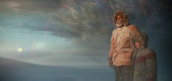 Movie still from “The Midnight Sky” (2020), directed by George Clooney – A man in a pink parka standing in front of a cloudy sky; Wide shot, Low angle
