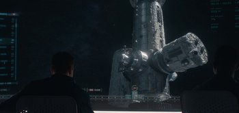 Movie still from “The Midnight Sky” (2020), directed by George Clooney – A man standing next to a building in the dark; Extreme Wide shot, Over the shoulder angle