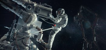 Movie still from “The Midnight Sky” (2020), directed by George Clooney – An image of an astronaut on a space station; Wide shot, Overhead angle