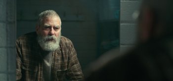 Movie still from “The Midnight Sky” (2020), directed by George Clooney – An older man with a beard and a plaid shirt; Close Up shot, Over the shoulder angle
