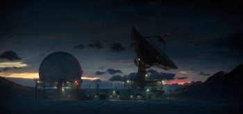 Movie still from “The Midnight Sky” (2020), directed by George Clooney – A large satellite dish sitting on top of an island; Extreme Wide shot, Low angle
