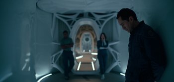 Movie still from “The Midnight Sky” (2020), directed by George Clooney – A man and two women in a tunnel; Medium shot, Low angle