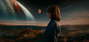Movie still from “The Midnight Sky” (2020), directed by George Clooney – A woman standing in front of an exoplanet; Extreme Wide shot, Over the shoulder angle