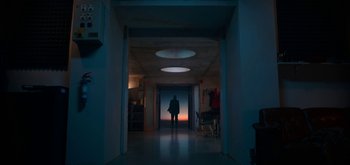 Movie still from “The Midnight Sky” (2020), directed by George Clooney – A person is standing in a dark hallway; Extreme Wide shot, Low angle