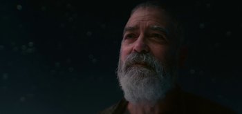 Movie still from “The Midnight Sky” (2020), directed by George Clooney – An old man with a beard and a white mustache; Close Up shot, Low angle