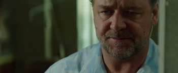 Movie still from “The Nice Guys” (2016), directed by Shane Black – A person with a beard; Close Up shot, Over the shoulder angle