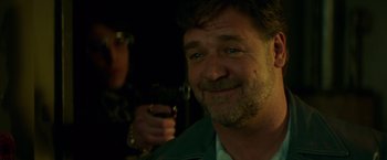 Movie still from “The Nice Guys” (2016), directed by Shane Black – A person holding a camera; Close Up shot, Over the shoulder angle