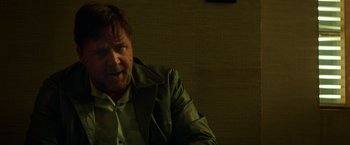 Movie still from “The Nice Guys” (2016), directed by Shane Black – A person sitting in a chair; Close Up shot, Low angle