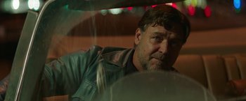 Movie still from “The Nice Guys” (2016), directed by Shane Black – A person wearing a jacket; Close Up shot, Low angle