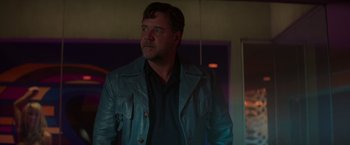 Movie still from “The Nice Guys” (2016), directed by Shane Black – A person wearing a leather jacket; Medium shot, Low angle