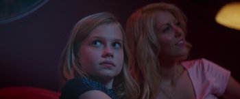 Movie still from “The Nice Guys” (2016), directed by Shane Black – A girl and a woman watching something in the dark; Close Up shot, Low angle