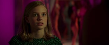 Movie still from “The Nice Guys” (2016), directed by Shane Black – A young girl with green eyes stares into the distance; Close Up shot, Over the shoulder angle