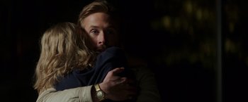 Movie still from “The Nice Guys” (2016), directed by Shane Black – A man holding a woman in his arms in the dark; Close Up shot, Over the shoulder angle