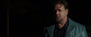 Movie still from “The Nice Guys” (2016), directed by Shane Black – A person wearing a black shirt; Close Up shot, Low angle