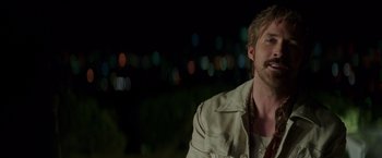 Movie still from “The Nice Guys” (2016), directed by Shane Black – A person wearing a jacket; Close Up shot, Over the shoulder angle