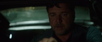 Movie still from “The Nice Guys” (2016), directed by Shane Black – A person sitting in a car; Close Up shot, Over the shoulder angle