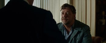 Movie still from “The Nice Guys” (2016), directed by Shane Black – A person sitting in front of another person; Close Up shot, Over the shoulder angle