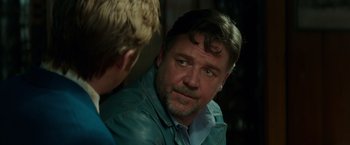 Movie still from “The Nice Guys” (2016), directed by Shane Black – A man in a blue jacket talking to another man in a blue jacket; Close Up shot, Over the shoulder angle