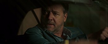 Movie still from “The Nice Guys” (2016), directed by Shane Black – A person wearing a blue shirt; Close Up shot, Over the shoulder angle