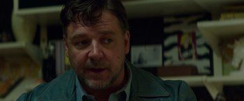 Movie still from “The Nice Guys” (2016), directed by Shane Black – A person wearing a jacket; Close Up shot, Over the shoulder angle