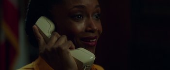 Movie still from “The Nice Guys” (2016), directed by Shane Black – A person talking on a phone; Close Up shot, Low angle