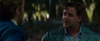 Movie still from “The Nice Guys” (2016), directed by Shane Black – A person wearing a leather jacket; Close Up shot, Over the shoulder angle