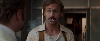 Movie still from “The Nice Guys” (2016), directed by Shane Black – A person smoking a cigarette; Close Up shot, Low angle