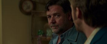 Movie still from “The Nice Guys” (2016), directed by Shane Black – A person wearing a shirt; Close Up shot, Over the shoulder angle