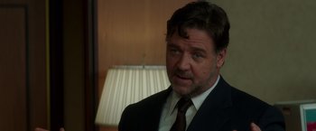 Movie still from “The Nice Guys” (2016), directed by Shane Black – A person wearing a suit and tie; Close Up shot, Over the shoulder angle