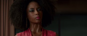 Movie still from “The Nice Guys” (2016), directed by Shane Black – A person wearing a pink shirt; Close Up shot, Low angle