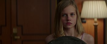 Movie still from “The Nice Guys” (2016), directed by Shane Black – A young girl is looking into the mirror; Close Up shot, Low angle