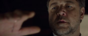 Movie still from “The Nice Guys” (2016), directed by Shane Black – A man's face and hand; Extreme Close Up shot, Low angle