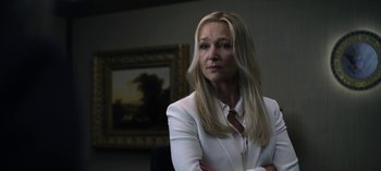 Movie still from “The Night Agent” (2023), created by Shawn Ryan – A woman in a white jacket and a tie; Close Up shot, Low angle
