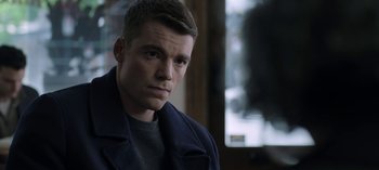 Movie still from “The Night Agent” (2023), created by Shawn Ryan – A person wearing a jacket; Close Up shot, Over the shoulder angle