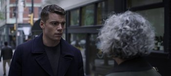 Movie still from “The Night Agent” (2023), created by Shawn Ryan – A man and a woman talking to each other; Close Up shot, Over the shoulder angle