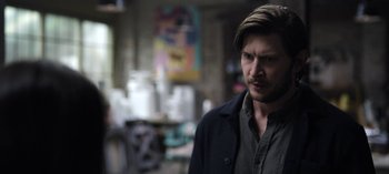 Movie still from “The Night Agent” (2023), created by Shawn Ryan – A person wearing a jacket; Close Up shot, Over the shoulder angle