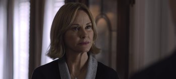 Movie still from “The Night Agent” (2023), created by Shawn Ryan – A person with short hair; Close Up shot, Over the shoulder angle