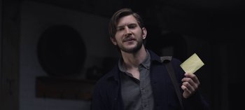 Movie still from “The Night Agent” (2023), created by Shawn Ryan – A man with a goatee and beard wearing a jacket; Close Up shot, Low angle