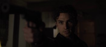 Movie still from “The Night Agent” (2023), created by Shawn Ryan – A person in a dark room; Close Up shot, Over the shoulder angle