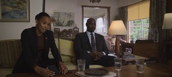 Movie still from “The Night Agent” (2023), created by Shawn Ryan – A man and a woman sitting at a coffee table; Medium shot, Over the shoulder angle