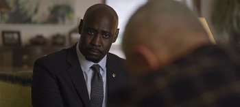 Movie still from “The Night Agent” (2023), created by Shawn Ryan – A man in a suit and a tie; Close Up shot, Over the shoulder angle