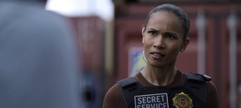 Movie still from “The Night Agent” (2023), created by Shawn Ryan – A person wearing a body armor; Close Up shot, Over the shoulder angle