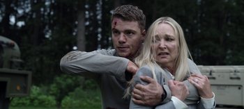 Movie still from “The Night Agent” (2023), created by Shawn Ryan – A man and a woman with blood on their face; Medium shot, Over the shoulder angle