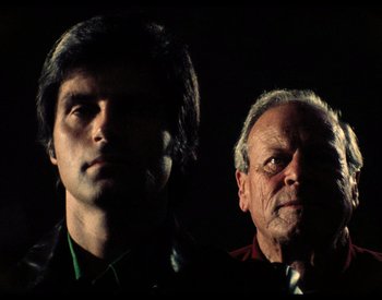 Movie still from “The Other Side of the Wind” (2018), directed by Orson Welles – A man and an older man standing next to each other; Close Up shot, Low angle