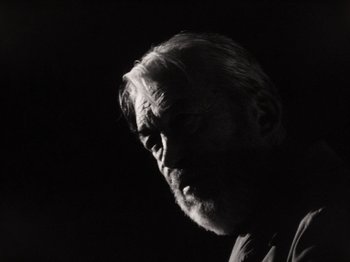 Movie still from “The Other Side of the Wind” (2018), directed by Orson Welles – An old man with a beard is looking into the distance; Close Up shot, Low angle