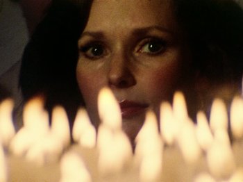 Movie still from “The Other Side of the Wind” (2018), directed by Orson Welles – A person looking at candles in a room; Close Up shot, Over the shoulder angle